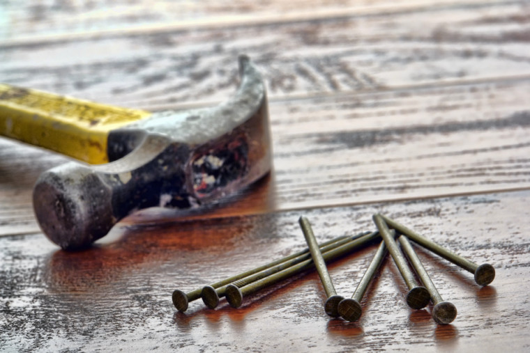 Claw Hammer and Nails on Wood Boards